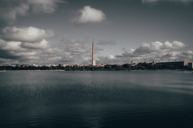 ATOP THE WASHINGTON MONUMENT, ARE DISPLAYED TWO WORDS: